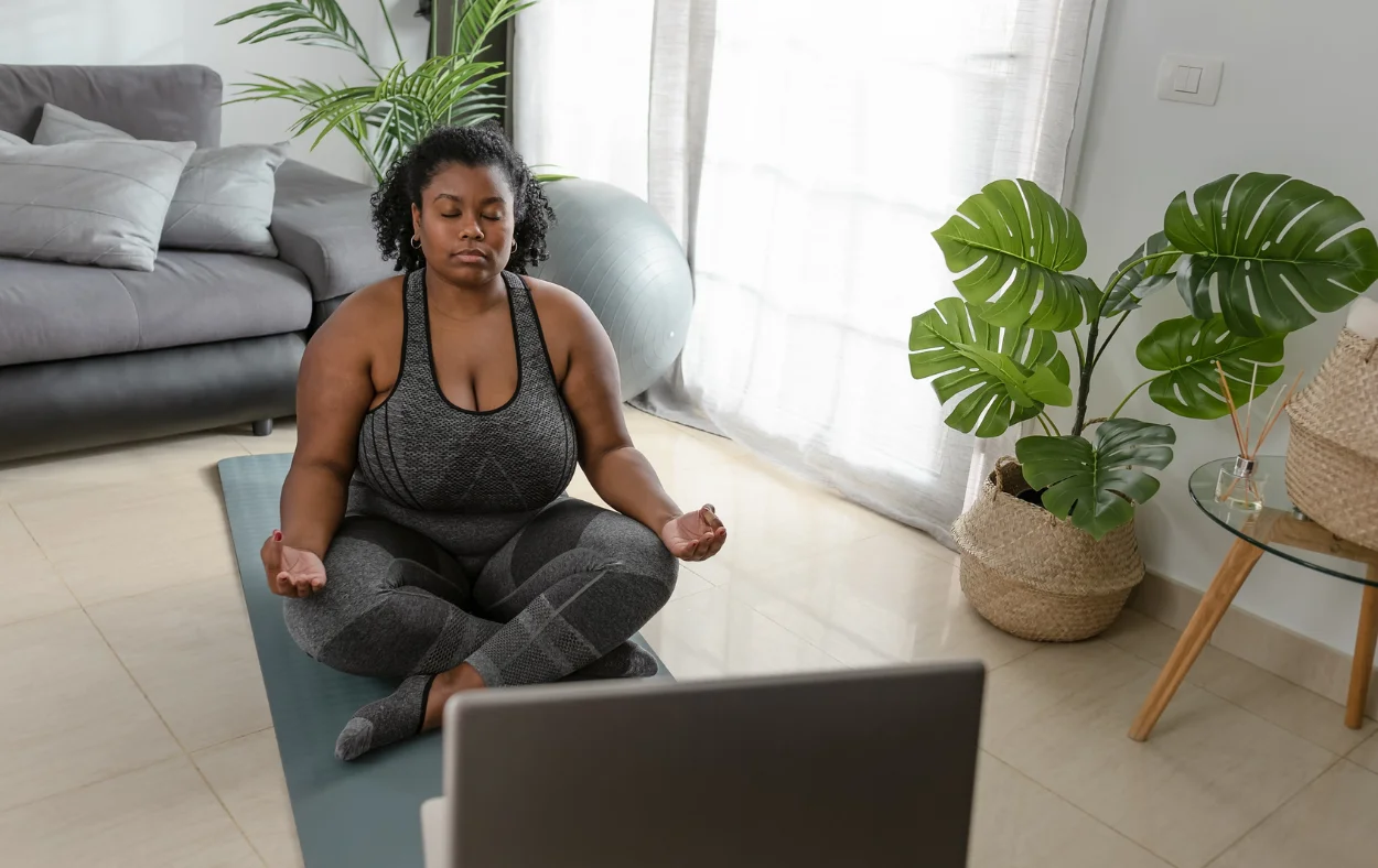Woman with legs crossed doing virtual yoga